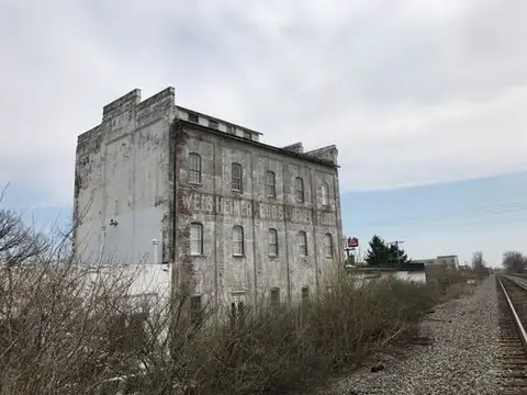 Time-worn walls tell tales by the tracks.
